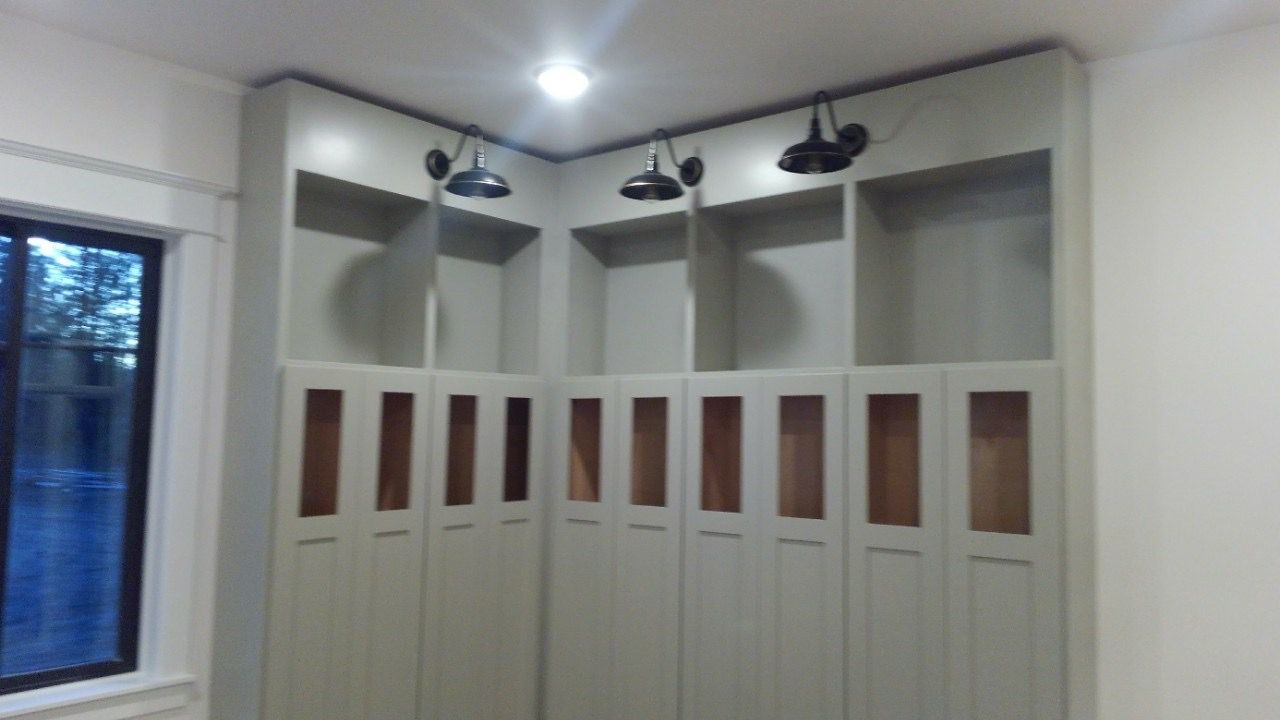 Barn-style sconces over mudroom lockers