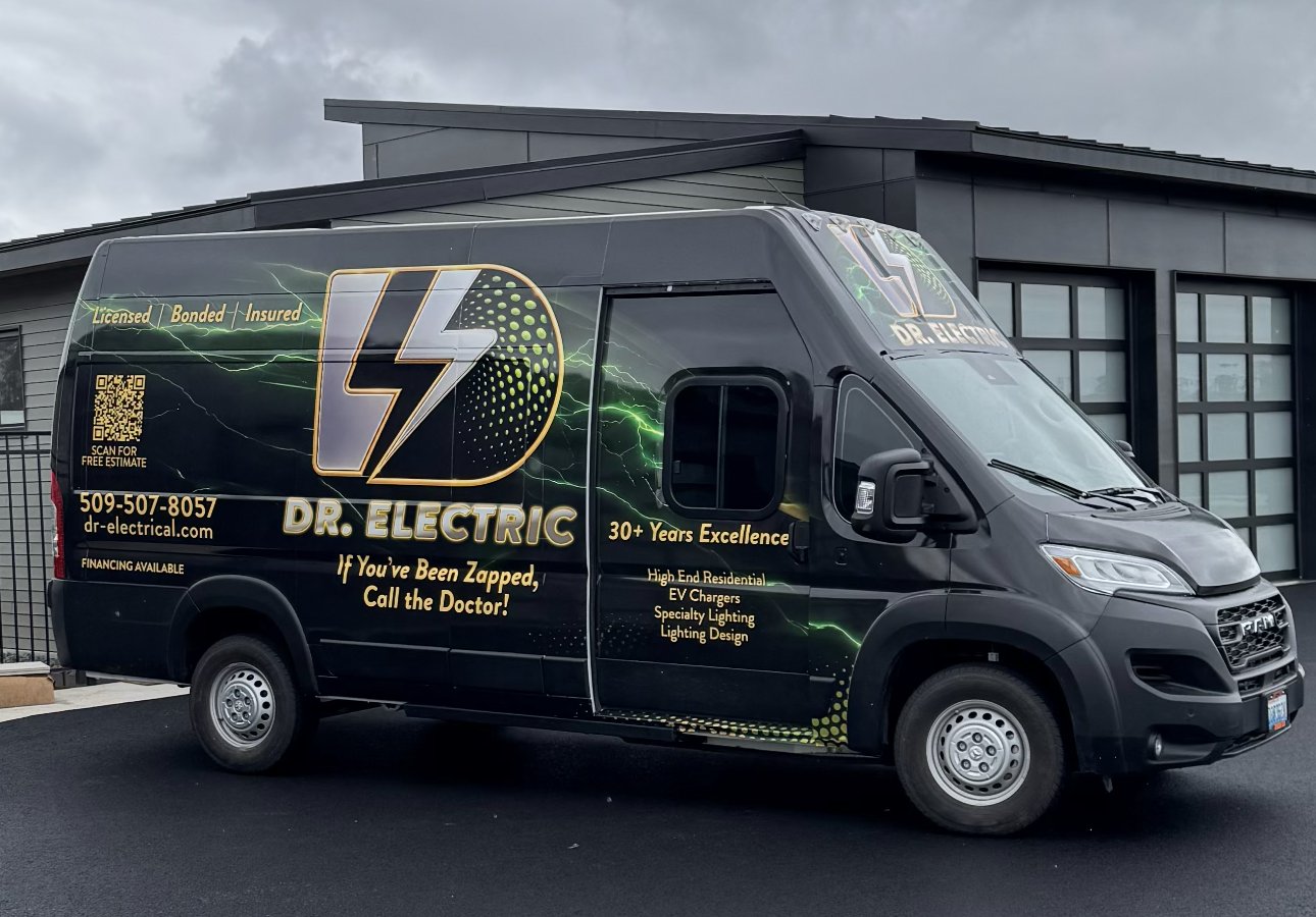 Dr. Electric wrapped work van parked in front of a modern shop building