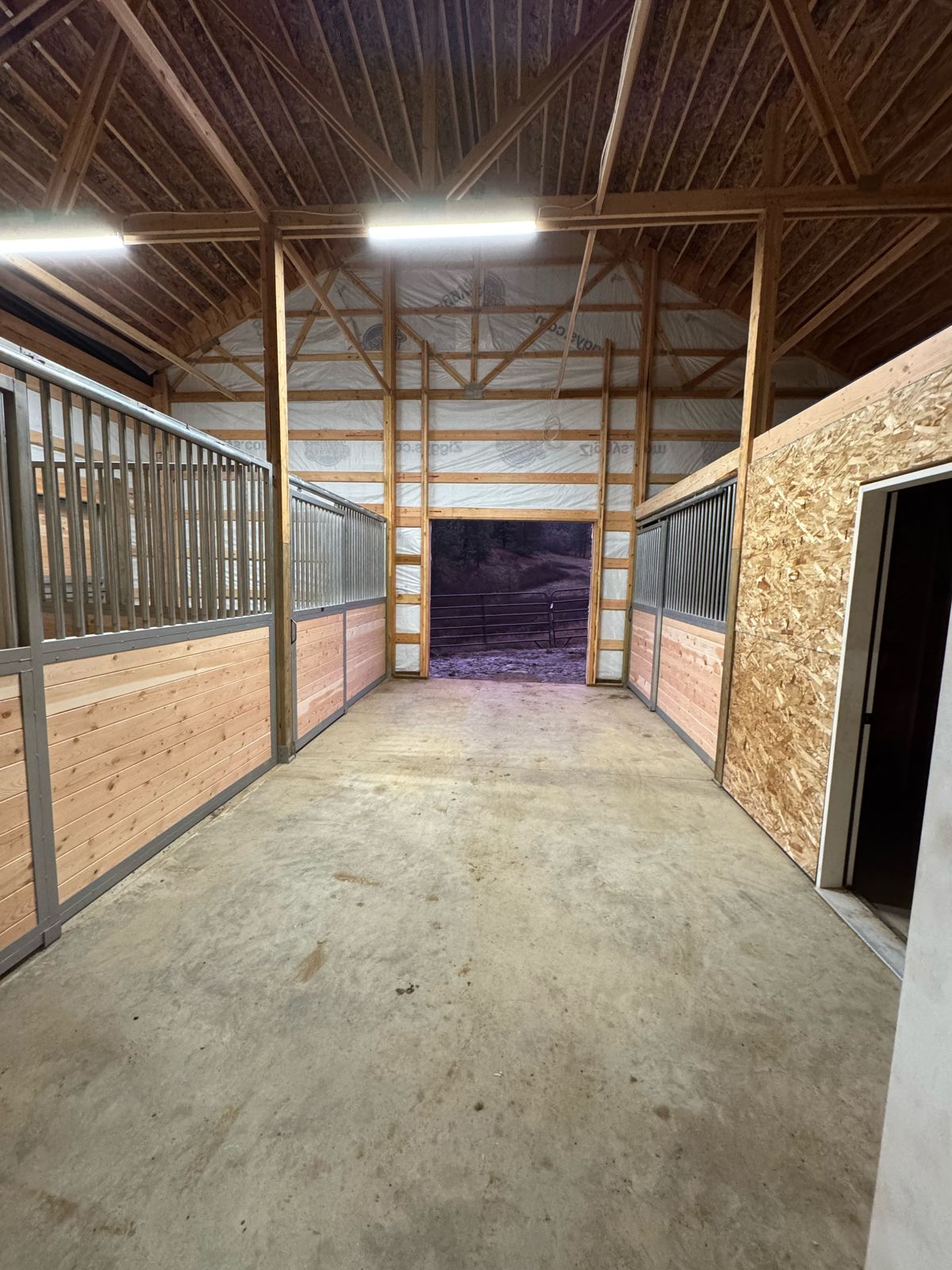 Horse barn aisle and stalls with LED lighting