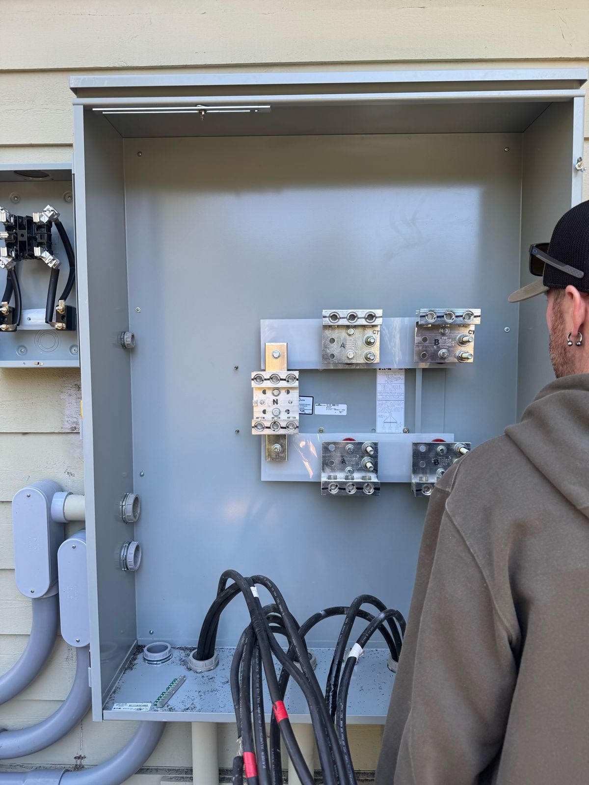 Dr. Electric electrician working on the bus bars inside the new service enclosure