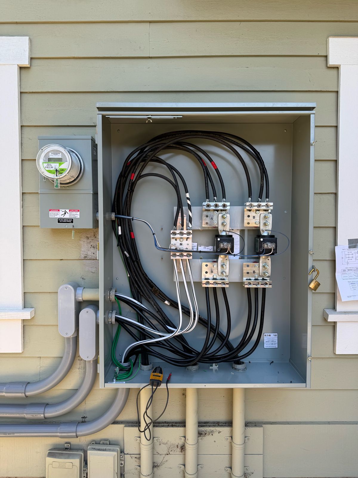 Neatly wired new electrical service enclosure with clean, organized conductors