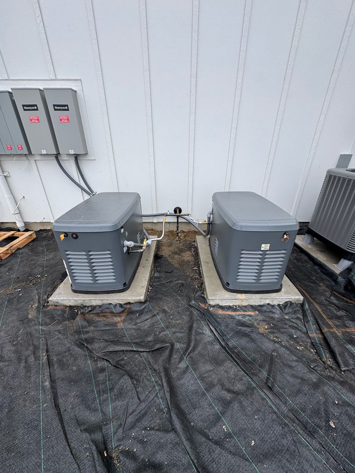 Twin Honeywell standby generators with automatic transfer switches installed at a home
