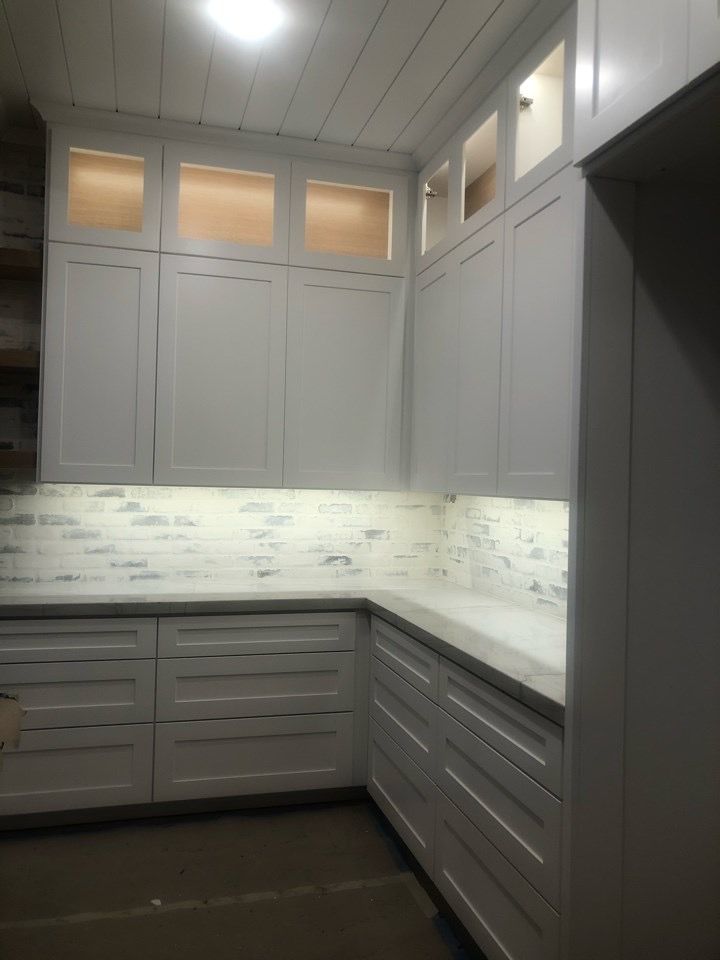 Under-cabinet and glass-front cabinet lighting in a kitchen
